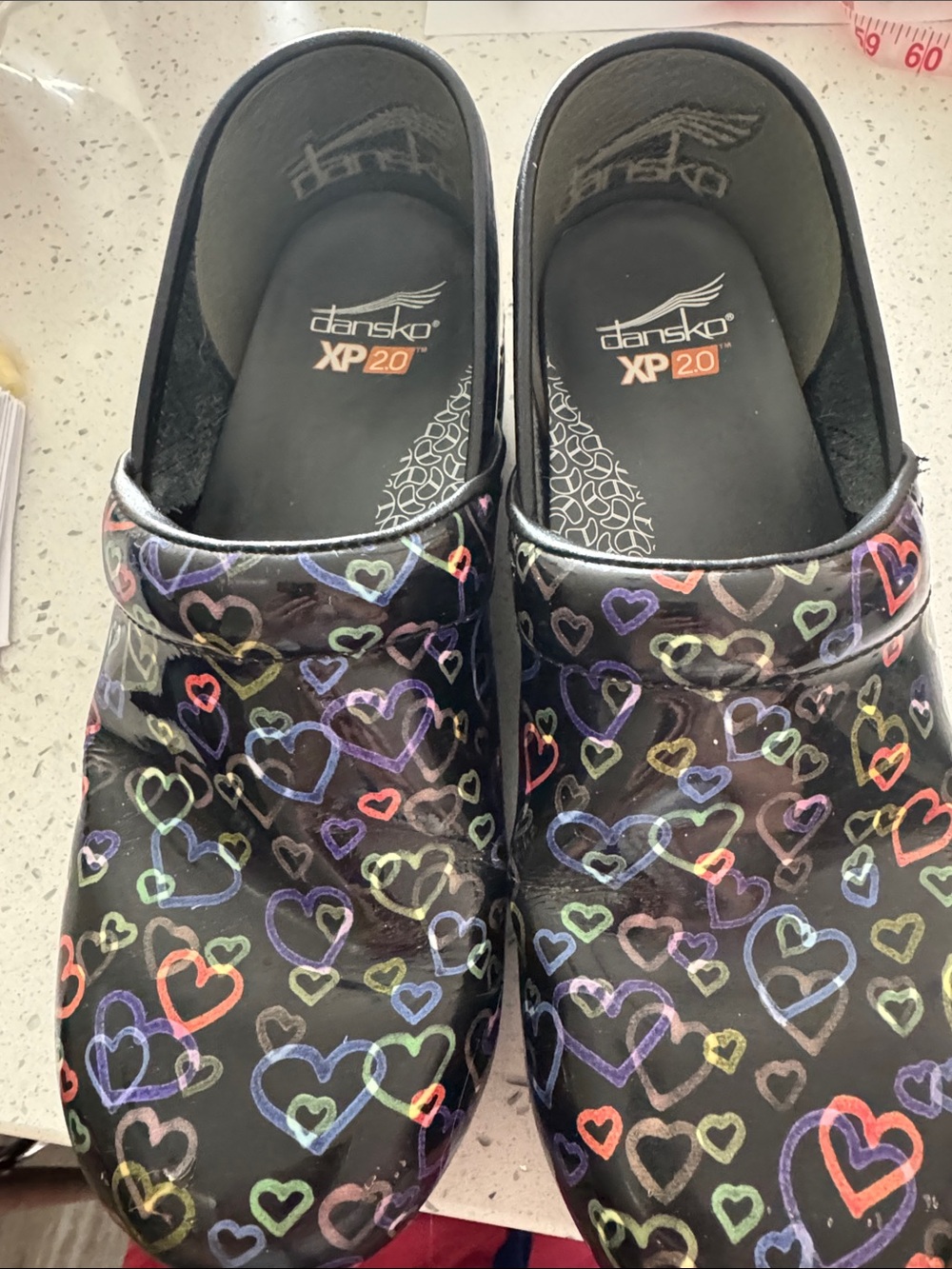 Dansko Black Clogs with Multicolor Heart Print